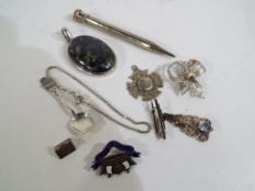 A collection of mostly silver jewellery to include pencil, pendants,