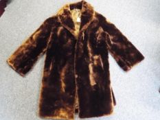 A good quality fur coat with side pockets, approximately 95 cm length.
