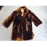 A good quality fur coat with side pockets, approximately 95 cm length.