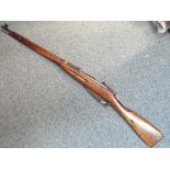 A deactivated U.S.S.R Mosin Nagant rifle chambered in 7.62. Serial number MM8447.