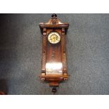 A Vienna-styled wall clock, walnut case with opening glazed door flanked by geometric decoration,