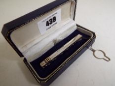 A gentleman's hallmarked silver tie clip with safety chain,