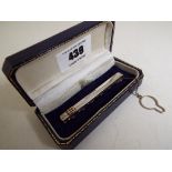 A gentleman's hallmarked silver tie clip with safety chain,