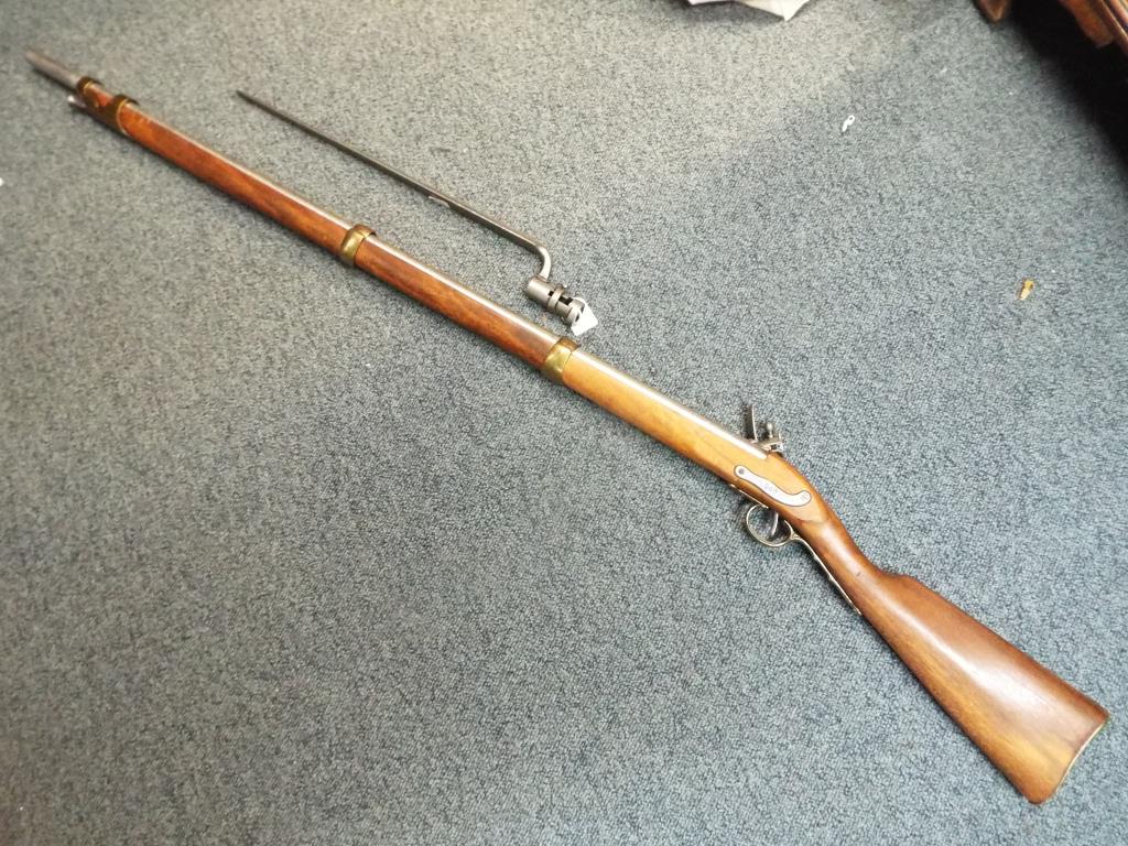 A replica French smoothbore flintlock rifle with bayonet.