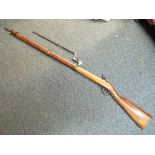 A replica French smoothbore flintlock rifle with bayonet.