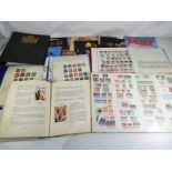 A good lot to include three albums containing a quantity of international stamps,