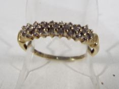 A lady's hallmarked 9 carat gold ring set with diamonds, size N and a half, approximate weight 1.