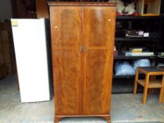 A good quality oak veneered two door gentleman's wardrobe with glass door compartments approx 183cm