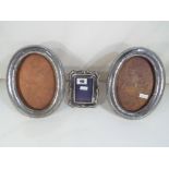 A pair of white metal photograph frames with Chinese dragon design and other