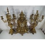 A large and impressive cast brass clock garniture,