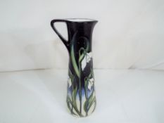 Moorcroft - a Moorcroft jug decorated in the Snow Fairy pattern, approximately 18.5 cm (h).