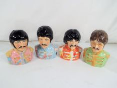 A set of four Beatles Toby jugs from the Bairstow Manor Collectables Collection modelled by Ray
