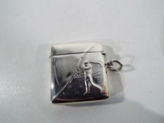 A silver Vesta case with relief decoration of a golfer.