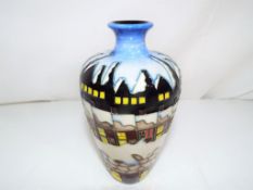 Moorcroft - a Moorcroft vase decorated in the Santa's Chimney pattern, approximate height 16 cm.