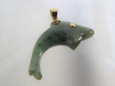 A 14ct gold and jade pendant shaped like