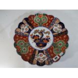 A large Imari shallow bowl with scallope