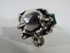 A gentleman's white metal ring depicting a skull in presentation box.
