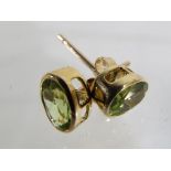 A pair of 9 carat gold and peridot solit