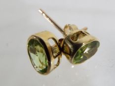 A pair of 9 carat gold and peridot solit