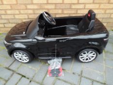 A Rastar child's electronic ride-on model of a Range Rover Evoque, approximate length 125 cm (l).