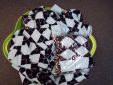 A container holding approximately 200 pairs of Pringle style diamond patterned socks (unused)