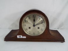 A good quality oak cased mantel clock with carved decoration,