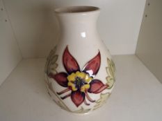 Moorcroft Pottery - a large bulbous vase decorated with Columbine on an ivorine ground,