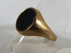 A hallmarked 9 carat yellow gold signet ring stone set, size T and a half, total weight 5.1 grams.