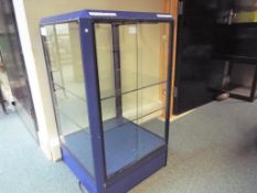 A display cabinet with internal glass shelves and a facility for illumination,