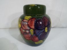 Moorcroft Pottery - a large Moorcroft Pottery ginger jar in the Clematis pattern on a green ground,