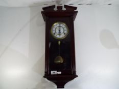 A Time Master wood cased wall clock,