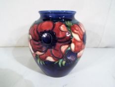 Moorcroft Pottery - a medium globular vase by Moorcroft Pottery in the Anemone pattern on a blue