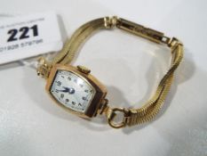 A lady's 9 carat gold cased Swiss wristwatch, Arabic numerals on a silvered dial,