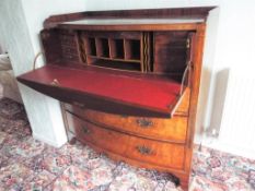 A bow fronted mahogany bureau with inlaid decoration,