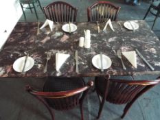 A faux marble table on cast iron supports,