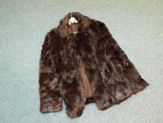 A size 12 fur coat, fully lined with slip pockets.