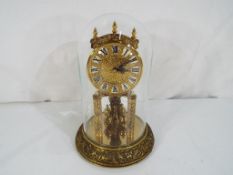 A decorative clock marked Kundo to the dial with Roman numerals and marked to the movement Made in