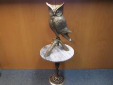 A large brass sculpture depicting an owl with marble topped stand, height of the bird 48 cm (h),