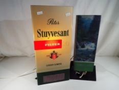 A pair of lamps advertising Consulate The Cool Cigarette and a Peter Stuyvesant Cigarettes with