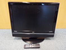 A UMC hdmi flat screen 21 inch portable television with remote control.