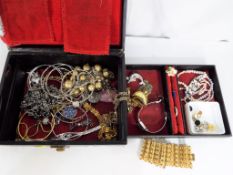 A double layered jewellery box containing a quantity of costume jewellery,