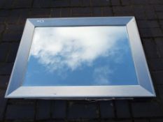 A large modern bevel edged wall mirror with silvered frame,