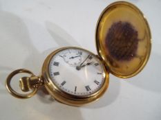 A gold plated full hunter pocket watch by Dennison Star with Roman numerals on a white dial with