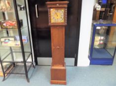 An early 20th century oak cased granddaughter clock,