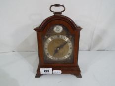 A wood cased mantel clock, Roman numerals to the dial marked 'Garrard & Co Ltd,