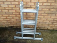 An aluminium four fold set of ladders.