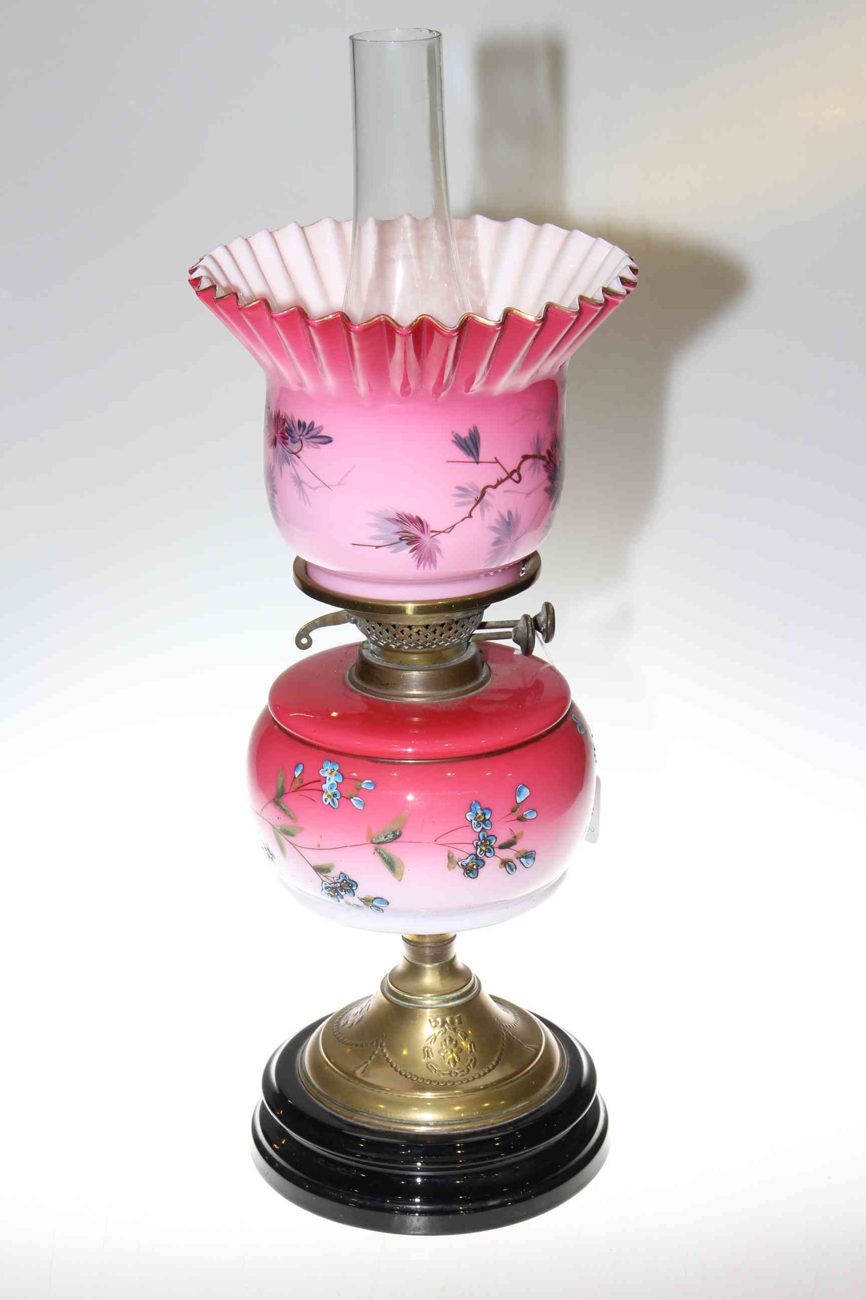 Victorian brass oil lamp with floral decorated pink reservoir and shade