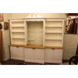 Large kitchen display cabinet having three double cupboards below an open and shelved top,