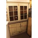 Painted mahogany cabinet bookcase having double cupboard below a double glazed door top