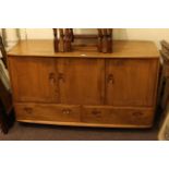 Ercol Windsor sideboard with three cupboard doors above three drawers
